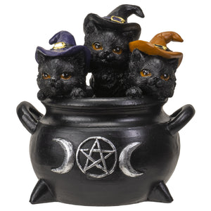 This figurine is three black kittens sitting inside a black cauldron. The three kittens have witch hats on and are smiling.